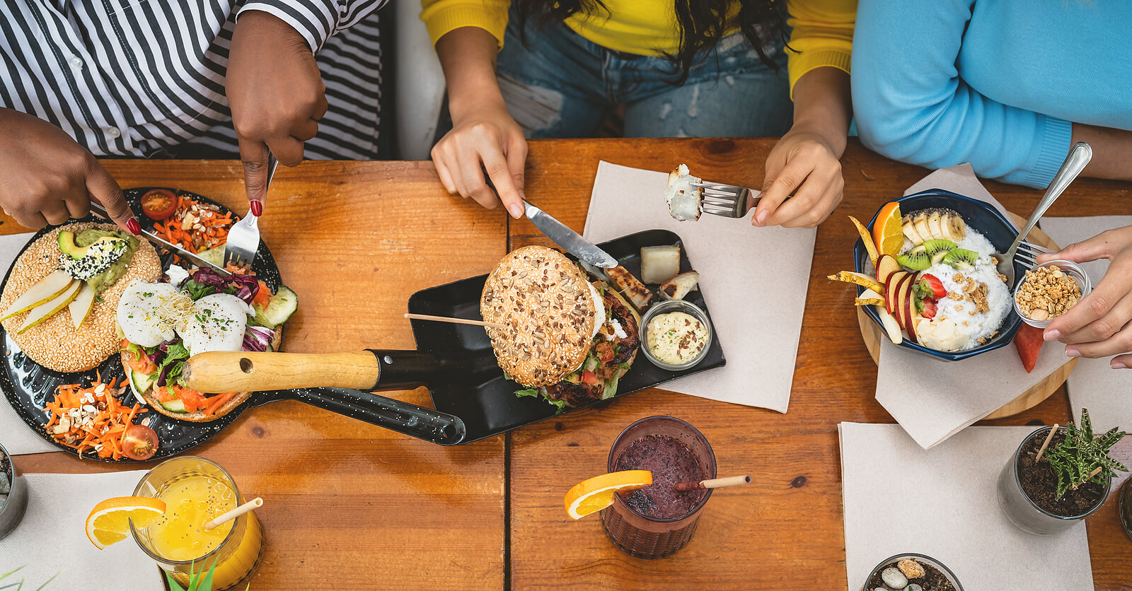 A bunch of hands over a table full of food. Want to experience more in life but social anxiety is stopping you? Start anxiety treatment in Evanston, IL to help you live a better life. 