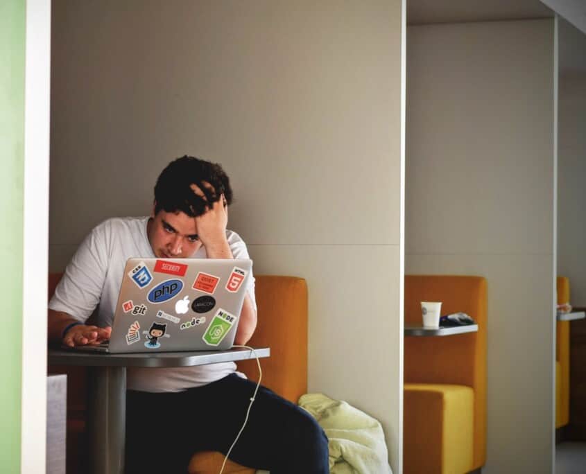 A college man is stressed while sitting in front of his laptop. Are you struggling adjusting to college life? Counseling for college students in Evanston, IL can help. Contact a therapist for college students in Illinois to learn more today!