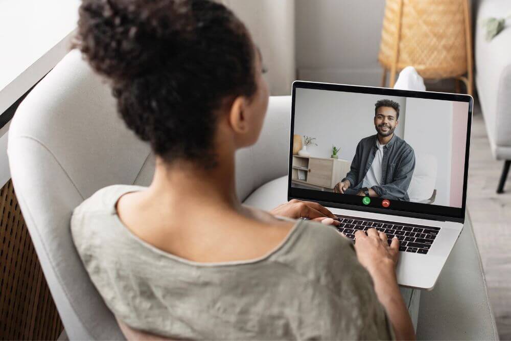 Therapist having an online session with client. Photo shows the concept on online therapy for anxiety, depression, and pain in Evanston, IL | 66021