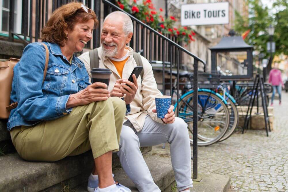 Mature couple waiting to go on a bike tour. The photo represents how therapy for empty nest syndrome in Evanston IL can help reduce anxiety or depression after your children leave home | 60201