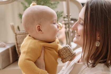 New mom holding infant | Every new mom needs support. You can find support in Evanston or online. Our Evanston Therapists are also here to help you.