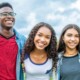 A group of teenagers smiling together. Looking to get your teen into Online Therapy for Teenagers in Evanston, IL? Speak with a therapist for teens in Illinois today!