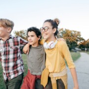 A group of teens walk together outside in a park. Want to help your teen develop in a healthy way? Speak with a teen therapist to learn how Therapy for Teenagers in Evanston, IL helps!