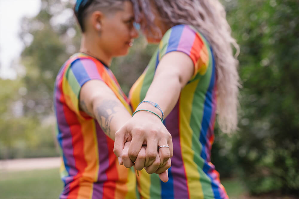 Two women hold hands while they look at each other. Looking to live a happier life but need some guidance? It might be time to try out LGBTQIA+ Affirmative Therapy in Evanston, IL. An LGBTQ+ affirming therapist can get you the help you need!