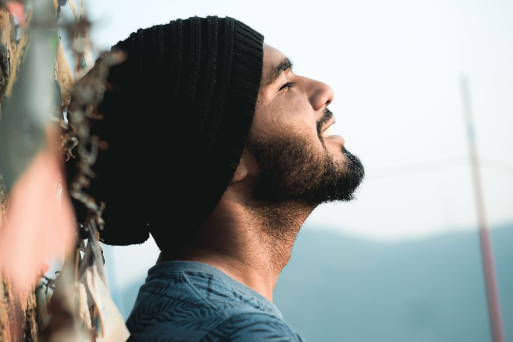 Millennial male sitting peacefully with head back and eyes closed. Want to better manage your anxiety? It might be time to seek out an anxiety therapist in Evanston, IL. Learn more about how Therapy for anxiety can help you!