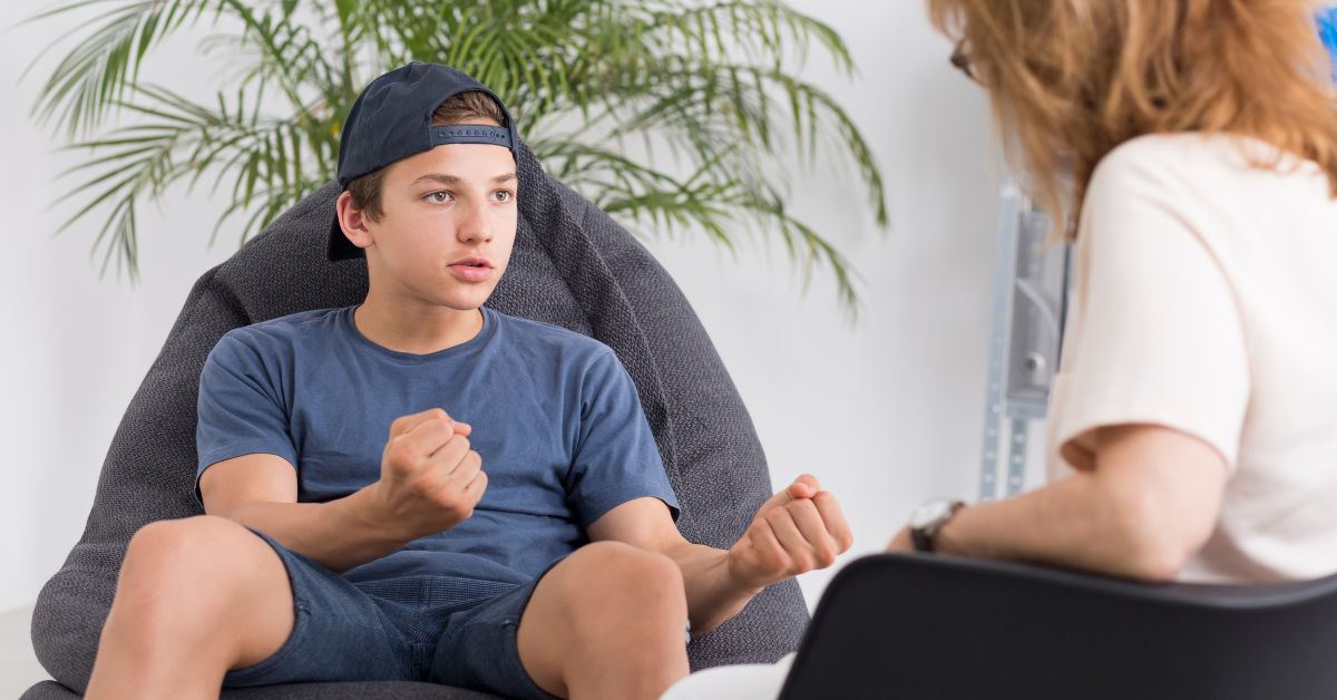 A teen sits in therapy with a teen therapist. Is your teen struggling? Reach out today for therapy with teenagers in Evanston, IL to see how a teen therapist can help them.