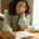 Teen girl looking stressed while studying at a desk, representing the emotional challenges many adolescents face—support is available through a therapist for teens in Evanston, IL, especially when school anxiety overlaps with maternal mental health in Evanston, IL.