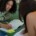 Two college students study together on the floor of a library, highlighting the pressures of academic life and the need for therapy for college students in Chicago, IL, with support from a therapist for college students in Chicago, IL.