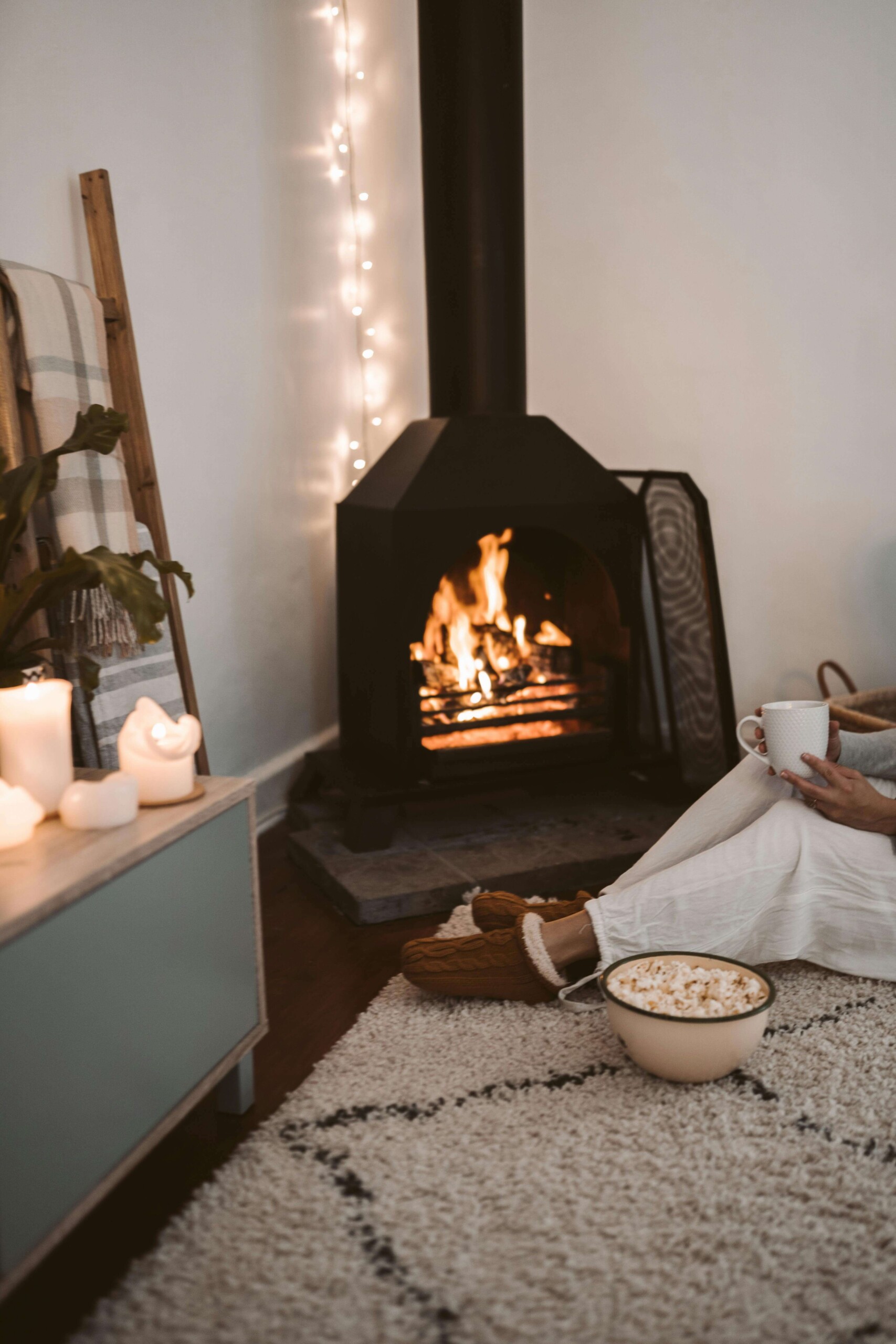 Cozy winter scene by a fireplace with warm lights, representing self-soothing and grounding tools taught in cognitive behavioral therapy in chicago, il, cognitive behavioral therapy in evanston, il, and cbt for anxiety in evanston, il. 