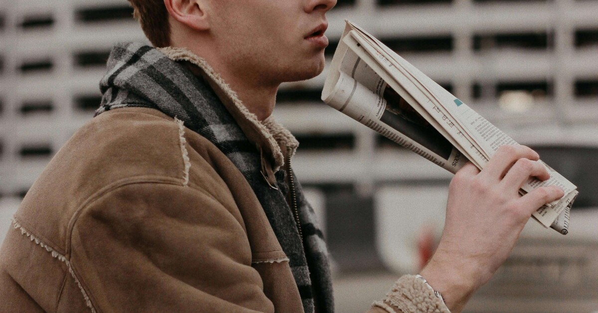 A college student in a tan jacket reading outdoors, representing the introspective journey of addressing functional depression through online therapy for college students in Chicago, IL and cognitive behavioral therapy in Chicago, IL.