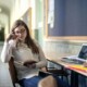 A college student studying at a desk with books and laptop, appearing thoughtful and focused—representing the experience of managing academic stress that can be supported through counseling for college students in Chicago with guidance from a therapist for college students in Chicago, IL.