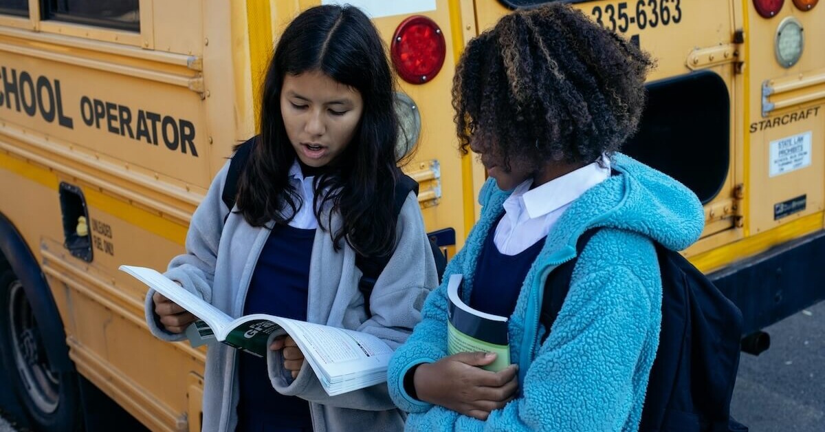 11:12 PMClaude responded: Two teen girls standing by a school bus reviewing papers together, representing the social navigation and academic pressures of high school that can be support…Two teen girls standing by a school bus reviewing papers together, representing the social navigation and academic pressures of high school that can be supported through an online therapist for teens in Evanston, IL and online therapy for teenagers in Evanston, IL.