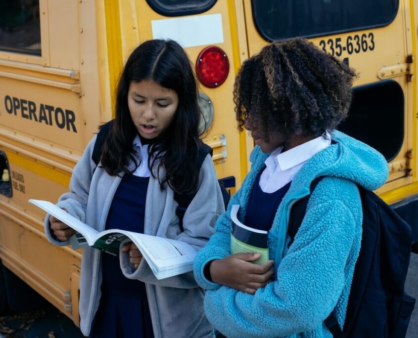 11:12 PMClaude responded: Two teen girls standing by a school bus reviewing papers together, representing the social navigation and academic pressures of high school that can be support…Two teen girls standing by a school bus reviewing papers together, representing the social navigation and academic pressures of high school that can be supported through an online therapist for teens in Evanston, IL and online therapy for teenagers in Evanston, IL.