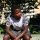 Teen boy sitting alone on a park bench looking thoughtful, representing the emotional challenges that therapy for teen boys Evanston can help address with support from a therapist for teens in Evanston, IL.