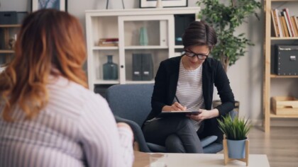 Seeking Support | therapy for college students in evanston, il | therapy in college in evanston, il | college burnout evanston | goals in college evanston | Lincoln Park, IL | Downtown Evanston, IL | Central Street District, IL A college student meeting with a therapist in a warm office setting, representing the supportive space where a therapist for college students in Evanston, IL can help you clarify goals for college in Evanston.